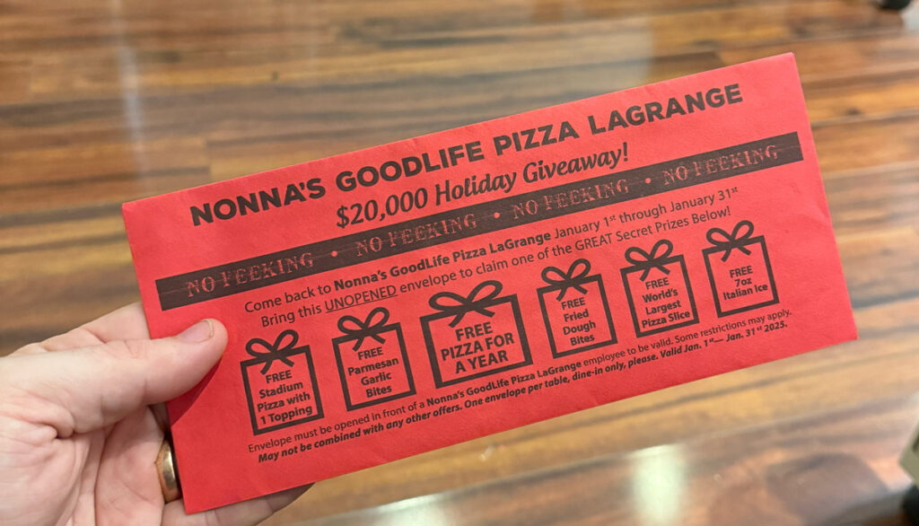 Holding a special red envelop from Nonna's Good Life Pizza in La Grange.